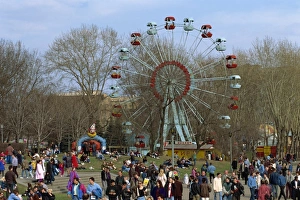 Big Wheel Prints: Crowds at a funfair with a big wheel during Earth Day