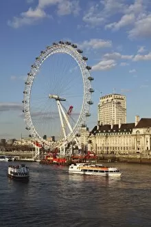 South Bank Collection: Cruise boats sail past County Hall and the London Eye on the South Bank of the River Thames