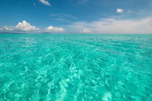 South Pacific Gallery: The crystal clear lagoon waters of French Polynesia on a calm sunny day, French Polynesia