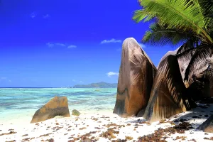 Retreat Prints: Crystal clear water and unique rock formations along a beach in Seychelles during bright sunny weather