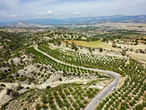 Highway Prints: Curvy road winds through dry landscape in mountains with view of Antalya province in Turkey