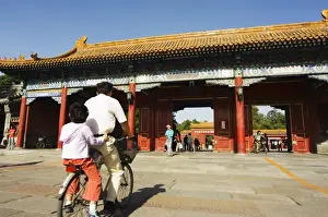 Zijin Cheng Prints: A cyclist at a gate to Zijin Cheng The Forbidden City Palace Museum