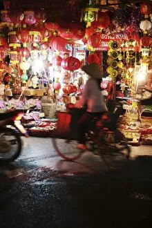 Images Dated 7th April 2007: Cyclist in front of lantern stall, Hanoi, Vietnam, Indochina, Southeast Asia, Asia