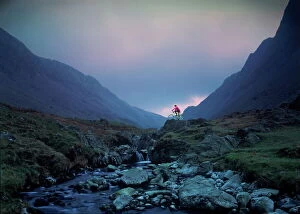 Stream Collection: Cyclist on mountain bike, Honister Pass, The Lake District, Cumbria, England