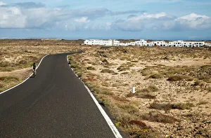 Open Space Prints: Cyclist on road at Caleta de Caballo village