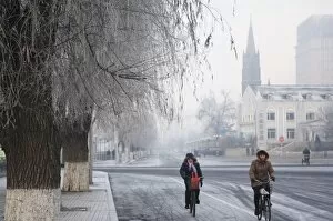 Cyclists in a winter wonderland and Catholic church in Jilin City, Jilin Province