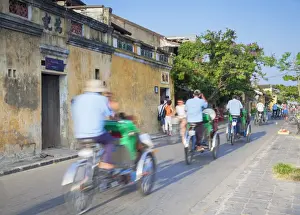 Hoi An Prints: Cyclos passing along street, Hoi An