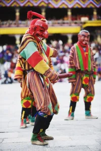 Costumes Prints: Dancer holding wooden penis, Autumn Tsechu (festival) at Trashi Chhoe Dzong