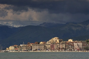 Overcast Skies Prints: Dark clouds over hills and the skyline of the town of St