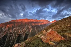 Muottas Muragl Prints: Dark clouds and sunset light frame the rocky peaks of Muottas Muragl, St. Moritz