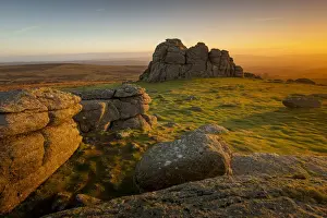 Dawn breaks and the early morning winter sunlight illuminates Haytor, Dartmoor, Devon