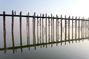Wooden Post Gallery: Dawn view of the famous U Bein teak bridge crossing Taungthaman Lake