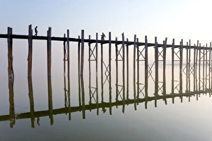 Wooden Post Gallery: Dawn view of the famous U Bein teak bridge crossing Taungthaman Lake