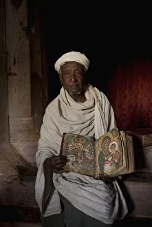 Debre Maryam monastery, priest showing off an old manuscript, Tana Lake, Ethiopia, Africa