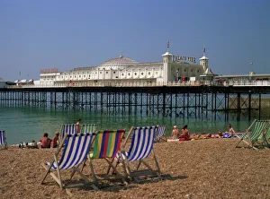 Empty deck chairs on the beach and the Brighton Pier, Brighton, Sussex Empty deck chairs on the beach and the Brighton Pier, Brighton, Sussex