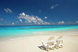 Two deck chairs on tropical beach facing sea, Maldives, Indian Ocean, Asia