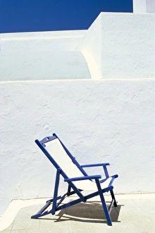 Imerovigli Prints: Deckchair against whitewashed wall