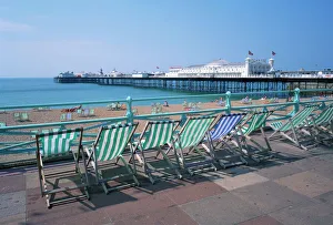 P Ier Prints: Deckchairs above the beach and the Palace Pier at Brighton, Sussex, England
