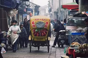 A decorated tricycle riding through the old streets of Suzhou, Jiangsu Province