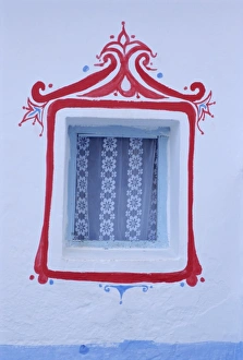 Decorated window in a white wall