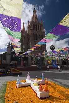 Hanging Prints: Decorations for the Day of the Dead festival with Parroquia de San Miguel Arcangel in the background