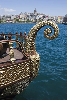 Decorative boat on the Golden Horn with the Galata Tower and Beyoglu district in the background Decorative boat on the Golden Horn with the Galata Tower and Beyoglu district in the background
