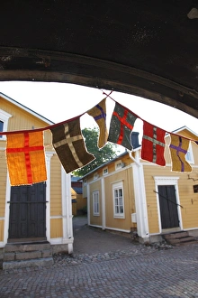 Single Storey Prints: Decorative flags and medieval wooden houses, Porvoo, Uusimaa, Finland, Scandinavia