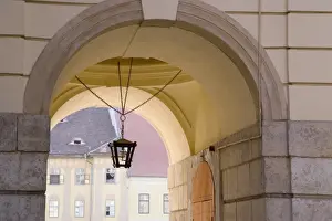 Romanian Prints: Decorative lantern hanging under an archway in the old towns main square