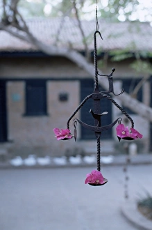 Tribal Prints: Decorative tribal metal sculpture outside a house