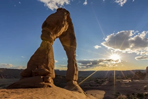 Moab Prints: Delicate Arch with sun and clouds at golden hour, Arches National Park, Moab, Grand County