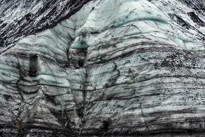Glacier Prints: Detailed view of striated face of Katla glacier displaying layers of ash