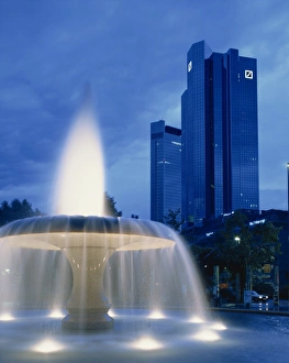 Frankfurt Prints: The Deutsche Bank with water fountain illuminated at dusk