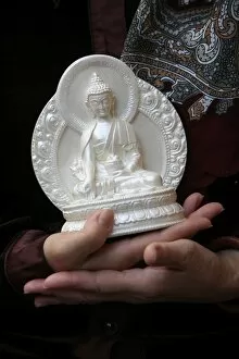 Devotee with Buddha statue, Paris, France, Europe