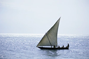 Dhow Prints: Dhow in silhouette on the Indian Ocean, off Stone Town, Zanzibar, Tanzania