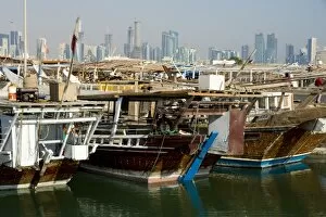 Images Dated 22nd November 2007: Dhows in Doha Bay and city skyline, Doha, Qatar, Middle East