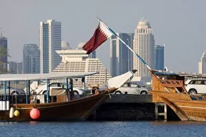 Images Dated 22nd November 2007: Dhows in Doha Bay and city skyline, Doha, Qatar, Middle East