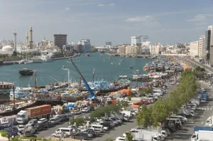 Images Dated 18th January 2008: Dhows moored for unloading alongside Deira wharves, minarets of the Grand Mosque in Buer Dubai