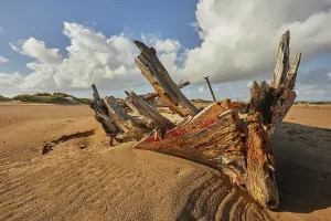 Dunes Prints: Disintegrating wreck rests on sand at Crow Point near Barnstaple in Devon, Great Britain
