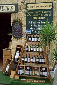 Wine Prints: Display of wine bottles outside a shop at St. Emilion in the Gironde, Aquitaine