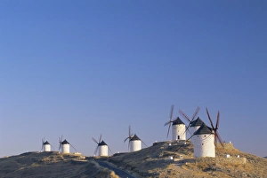 Consuegra Prints: Distant view of hilltop windmills