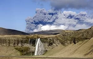 Images Dated 10th May 2010: Distant view of the Seljalandsfoss waterfall with the ash plume of the Eyjafjallajokull eruption