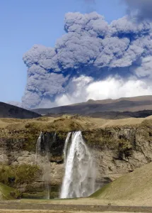 Heat Prints: Distant view of the Seljalandsfoss waterfall with the ash plume of the Eyjafjallajokull eruption in the distance