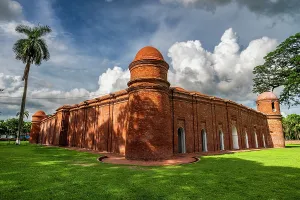 Pilgrimage Prints: Sixty Dome Mosque in Bhagerat features red brick architecture under a cloudy sky in Bangladesh