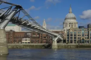 The Dome of St. Pauls Cathedral and Millennium Bridge over the River Thames