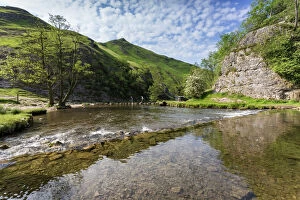Flowing Gallery: Dovedale reflections, hikers on stepping stones and Thorpe Cloud, limestone gorge in spring