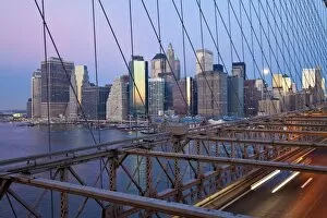 Downtown Financial District skyline of Manhattan viewed from the Brooklyn Bridge at dawn