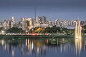Public Park Prints: The downtown urban skyline reflected in Lago das Garcas lake at twilight