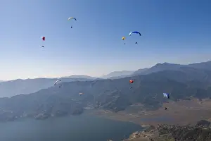 Mid Air Prints: Dozens of paragliders enjoy amazing views of the Himalayas above Phewa Lake, Nepal, Asia