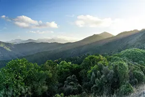 Sounds Prints: Dramatic Light Rays Breaking Through Evening Cloud Over Lush Hills Along French Pass Road