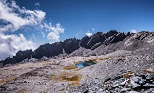 Rugged Terrain Prints: Dramatic rugged mountain range with a lake